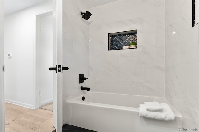 5640 Niagara St, Commerce City, CO 80022 - full bathroom featuring bathing tub / shower combination and wood finished floors