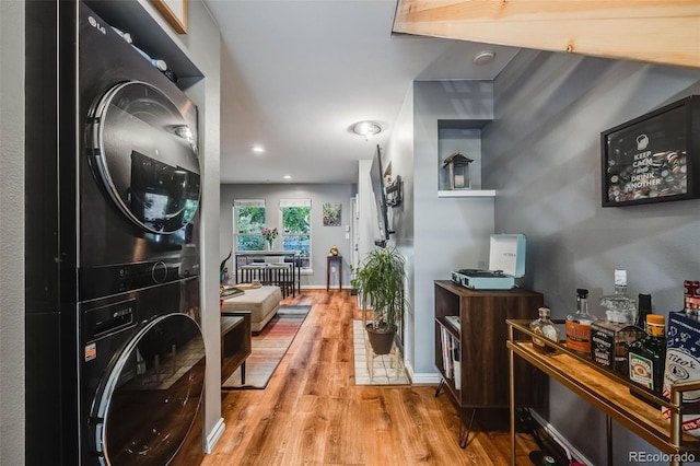 1150 Inca St Unit 43, Denver, CO 80204 - foyer featuring estacked washer and dryer, wood finished floors, and baseboards