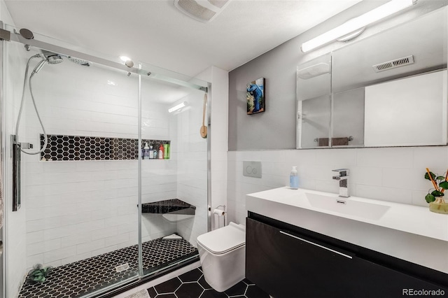 1150 Inca St Unit 43, Denver, CO 80204 - bathroom with vanity, a shower stall, tile walls, toilet, and tile patterned floors