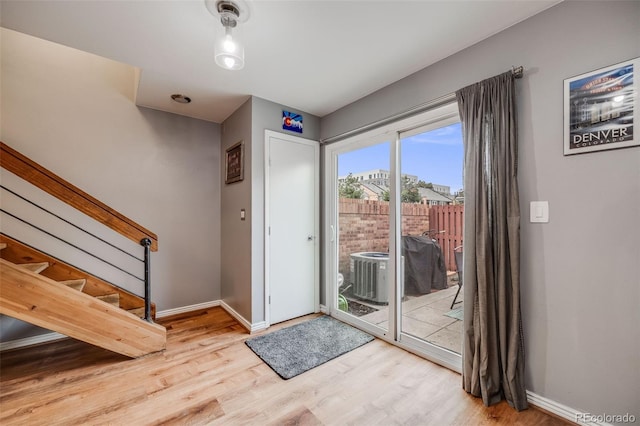 1150 Inca St Unit 43, Denver, CO 80204 - doorway to outside featuring wood finished floors, stairs, and baseboards