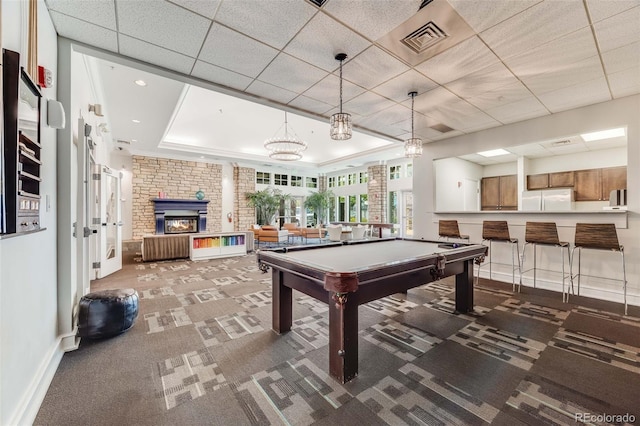 1150 Inca St Unit 43, Denver, CO 80204 - playroom featuring a tray ceiling, carpet floors, baseboards, billiards, and a brick fireplace