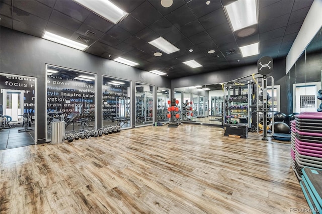 1150 Inca St Unit 43, Denver, CO 80204 - workout area with wood finished floors, a drop ceiling, and a towering ceiling
