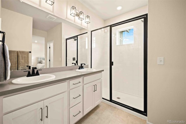 full bathroom with double vanity, ensuite bathroom, a stall shower, and a sink