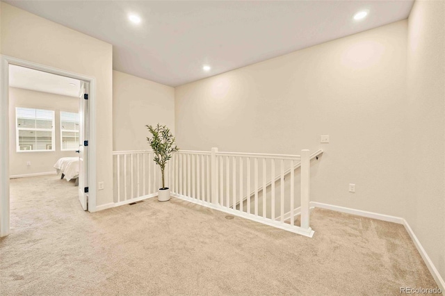 spare room featuring baseboards, recessed lighting, and carpet