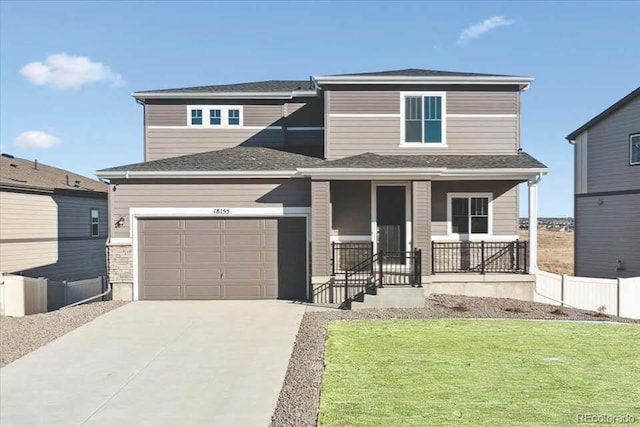 view of front of property with a garage, a front yard, and a porch