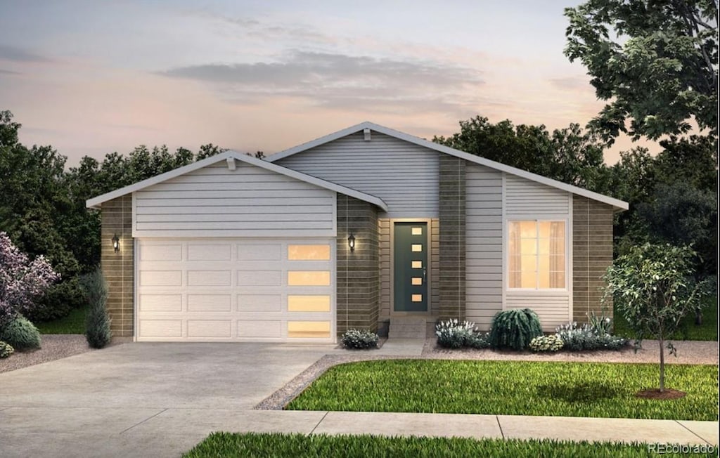 view of front of home with a garage and a yard