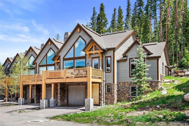 200 Antler Way, Winter Park, CO 80482 - view of front of property with stone siding, a garage, driveway, a chimney, and a shingled roof