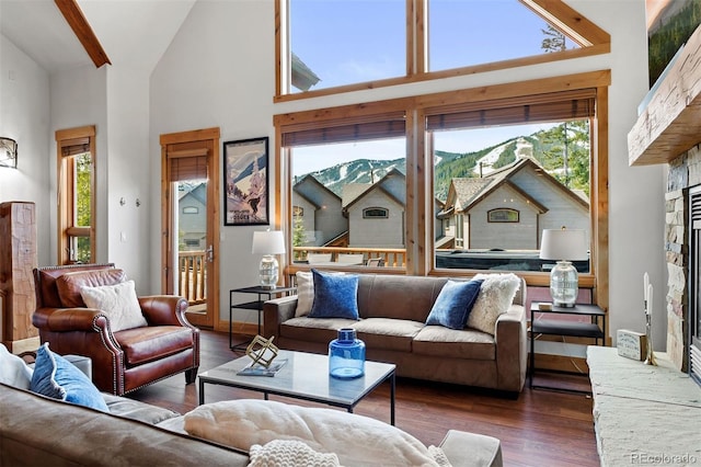 200 Antler Way, Winter Park, CO 80482 - living room featuring high vaulted ceiling, wood finished floors, plenty of natural light, and a stone fireplace