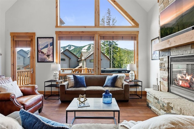 200 Antler Way, Winter Park, CO 80482 - living room with a fireplace, wood finished floors, high vaulted ceiling, and baseboards