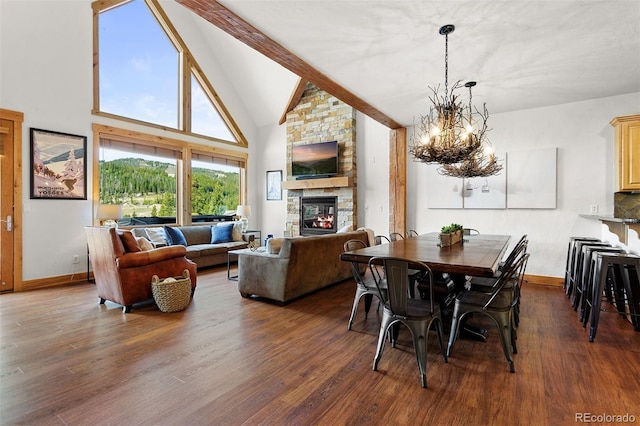 200 Antler Way, Winter Park, CO 80482 - dining room with a stone fireplace, a chandelier, baseboards, dark wood-type flooring, and beamed ceiling