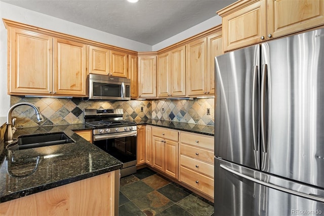 200 Antler Way, Winter Park, CO 80482 - kitchen with stainless steel appliances, a sink, light brown cabinetry, tasteful backsplash, and stone finish flooring