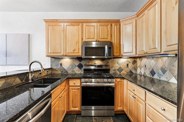 200 Antler Way, Winter Park, CO 80482 - kitchen with stainless steel appliances, a sink, dark stone countertops, tasteful backsplash, and light brown cabinets