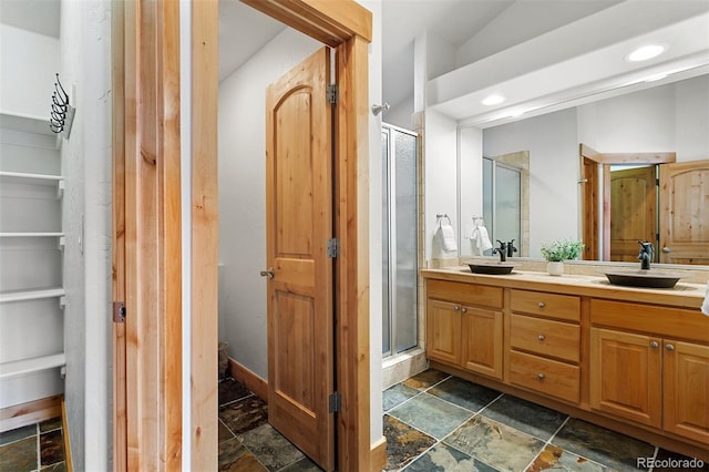 200 Antler Way, Winter Park, CO 80482 - full bath featuring stone tile flooring, double vanity, a shower stall, recessed lighting, and a walk in closet