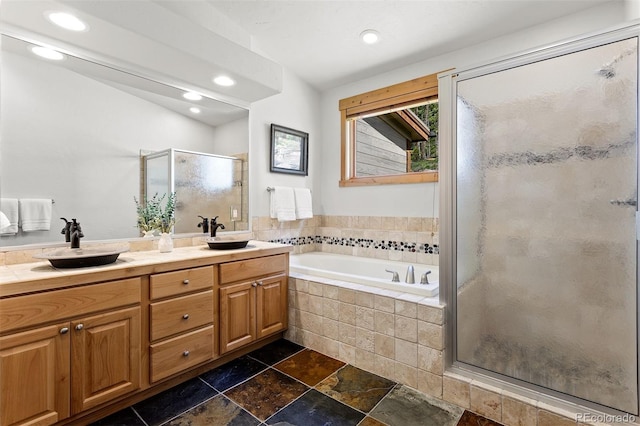 200 Antler Way, Winter Park, CO 80482 - bathroom featuring a stall shower, double vanity, recessed lighting, a garden tub, and stone tile flooring