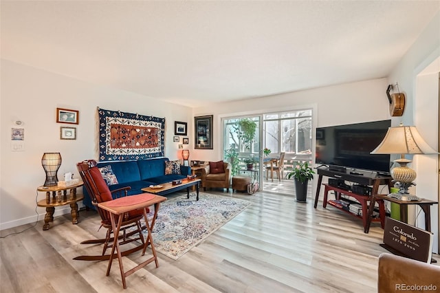 living room featuring wood finished floors and baseboards