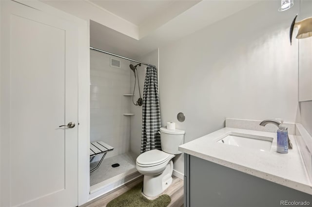 full bathroom with visible vents, a stall shower, vanity, and toilet