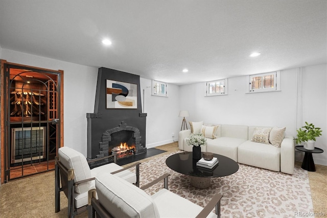 living room with a large fireplace and carpet floors