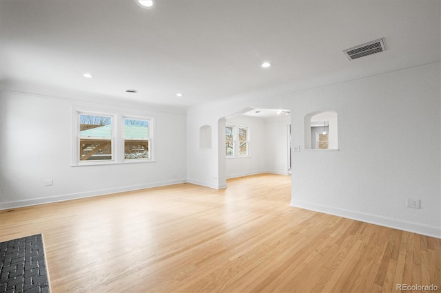 empty room with light hardwood / wood-style floors and ornamental molding