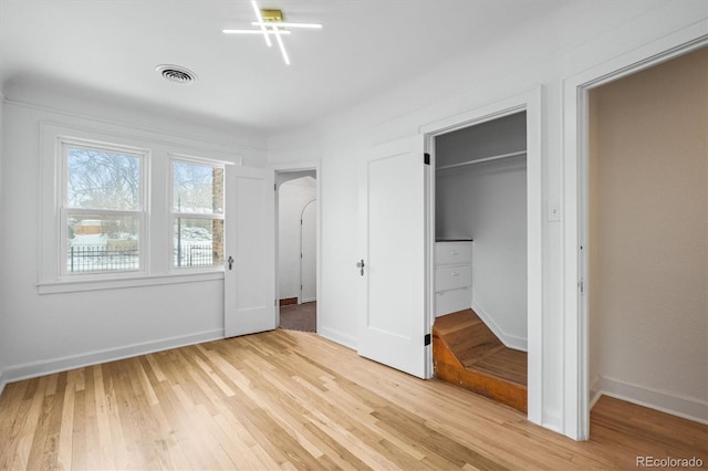 unfurnished bedroom with light wood-type flooring