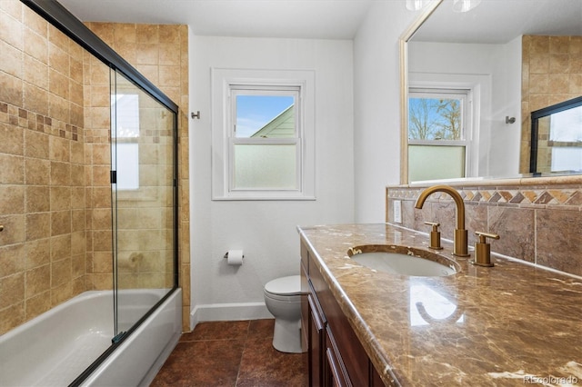 full bathroom featuring vanity, toilet, plenty of natural light, and enclosed tub / shower combo