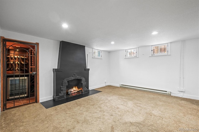 unfurnished living room with a fireplace, carpet floors, and a baseboard radiator