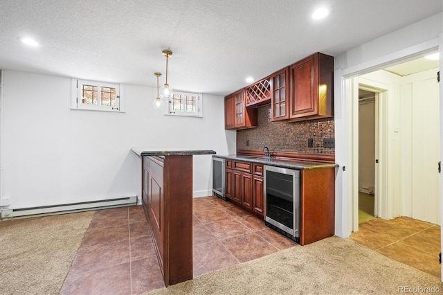 kitchen featuring sink, decorative backsplash, baseboard heating, decorative light fixtures, and beverage cooler