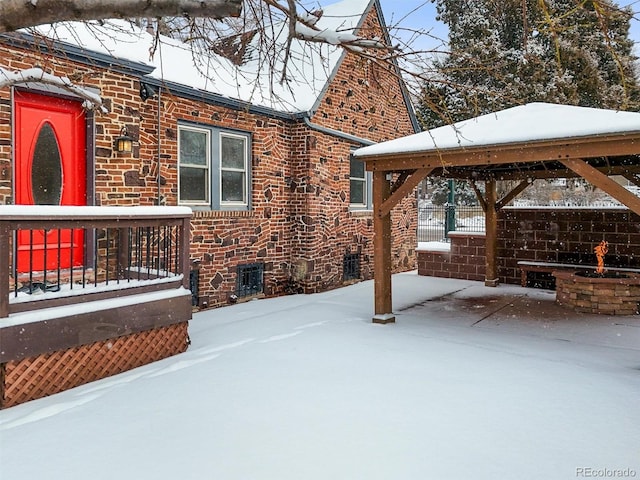 snow covered patio with a gazebo