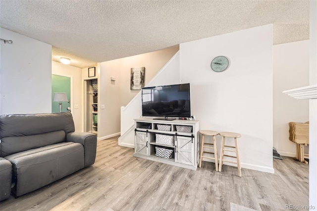 11636 Community Center Dr Unit 29, Northglenn, CO 80233 - living area featuring wood finished floors and a textured ceiling