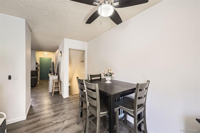 11636 Community Center Dr Unit 29, Northglenn, CO 80233 - dining area with wood finished floors, a ceiling fan, and a textured ceiling