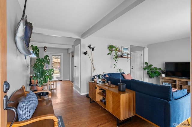 living room with beamed ceiling, baseboards, and wood finished floors