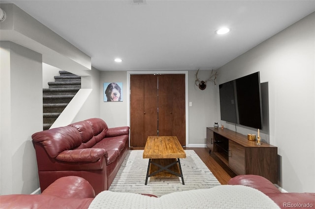 living room with stairs, baseboards, wood finished floors, and recessed lighting