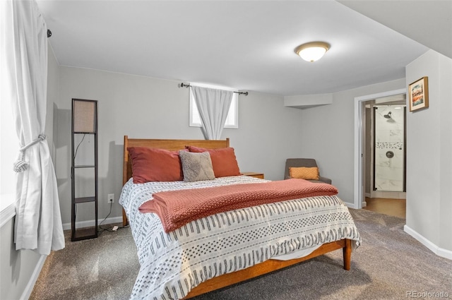 bedroom featuring ensuite bath, carpet flooring, and baseboards