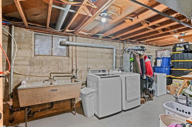 laundry area with a sink, laundry area, and washer and dryer