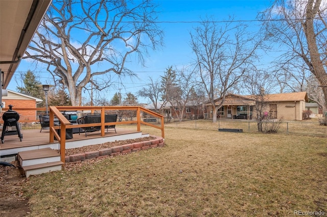 view of yard with fence and a deck