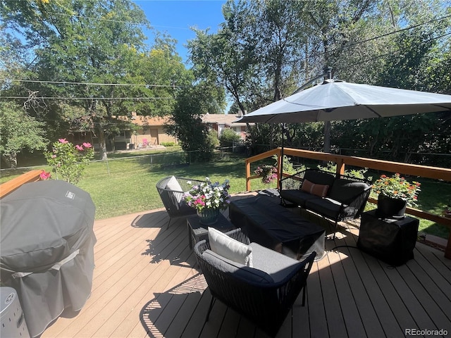 wooden deck featuring fence, a yard, grilling area, and an outdoor hangout area