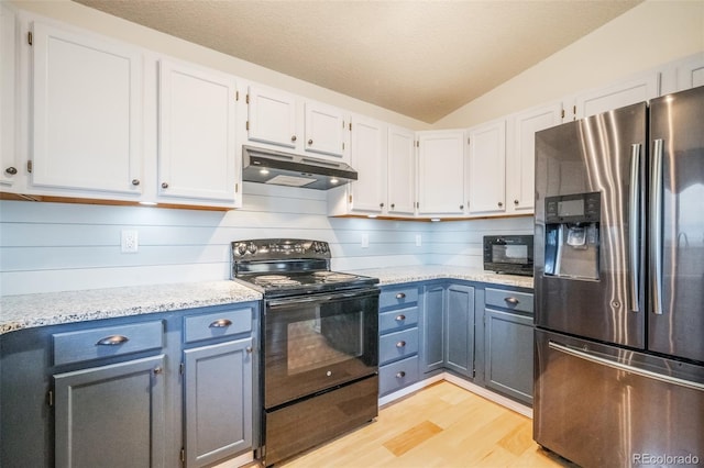 kitchen featuring black appliances, vaulted ceiling, light hardwood / wood-style flooring, light stone counters, and white cabinetry