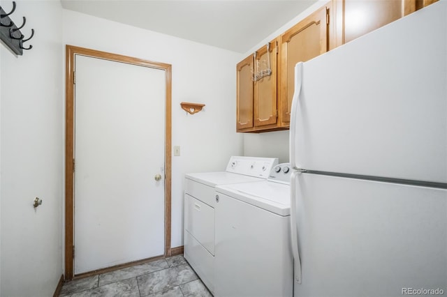 laundry room featuring washing machine and dryer and cabinets