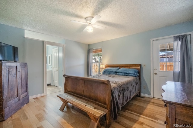 bedroom with ceiling fan, light wood-type flooring, and a textured ceiling