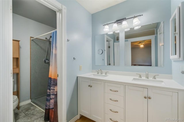 bathroom with vanity, toilet, and curtained shower