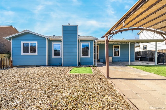 rear view of property featuring a patio