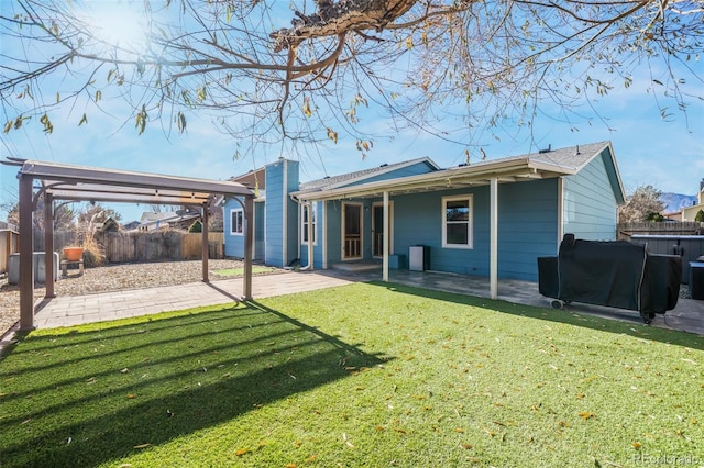 back of house with a patio area and a yard