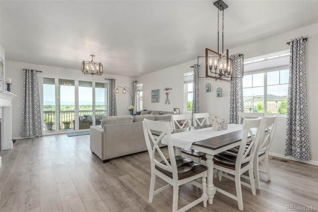 12513 Shore Point St, Firestone, CO 80504 - dining area with a chandelier, healthy amount of natural light, and light wood-style flooring