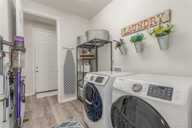 12513 Shore Point St, Firestone, CO 80504 - laundry area featuring washing machine and clothes dryer, light wood-style flooring, and baseboards