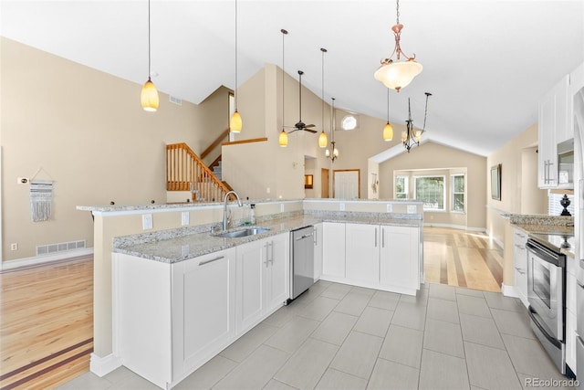 kitchen featuring appliances with stainless steel finishes, white cabinetry, pendant lighting, and sink