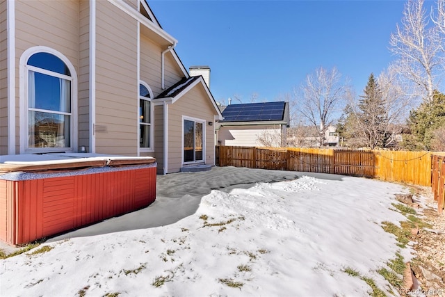 exterior space with a hot tub