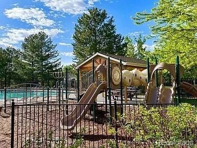 view of jungle gym with a community pool