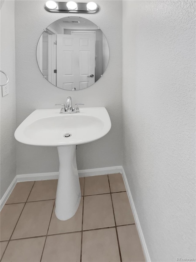 bathroom featuring tile patterned flooring and sink