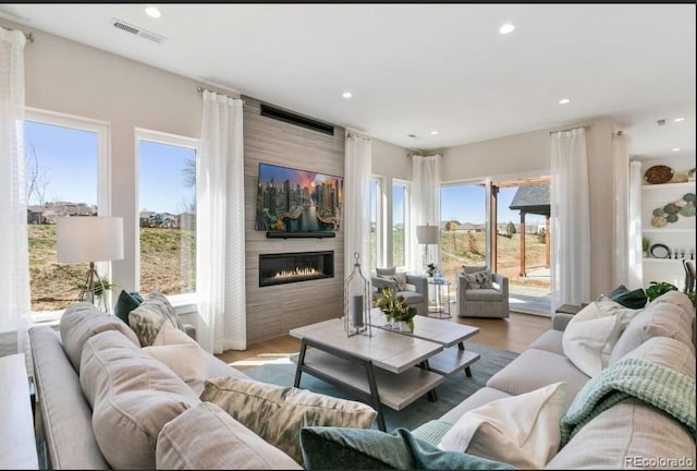 1736 Barefoot Dr, Windsor, CO 80550 - living area with a large fireplace, wood finished floors, and recessed lighting