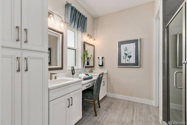 1736 Barefoot Dr, Windsor, CO 80550 - bathroom featuring double vanity, a stall shower, and wood finished floors