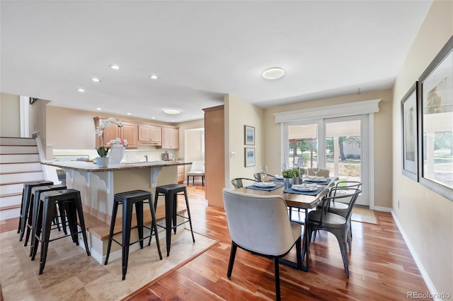 dining space with light wood-type flooring